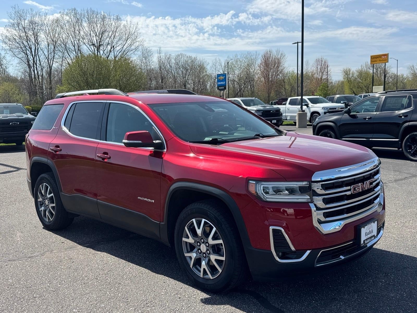 2023 GMC Acadia SLT in Volcanic Red Tintcoat — front three-quarter view